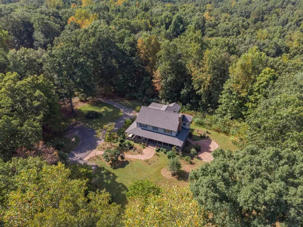 an aerial view of a house with a yard