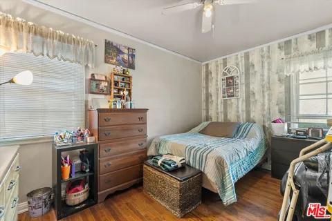 a living room with furniture a floor to ceiling window and a flat screen tv