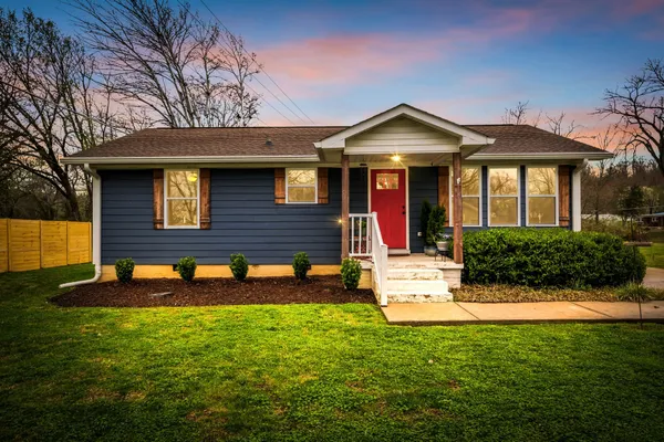 a front view of a house with yard and seating area