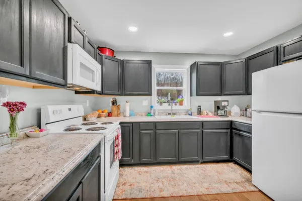 a kitchen with refrigerator and sink