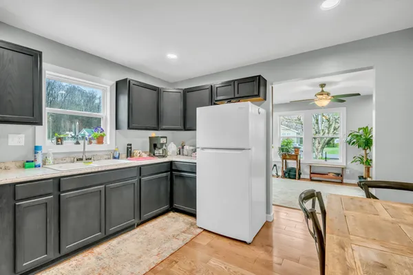 a kitchen with a sink window and cabinets