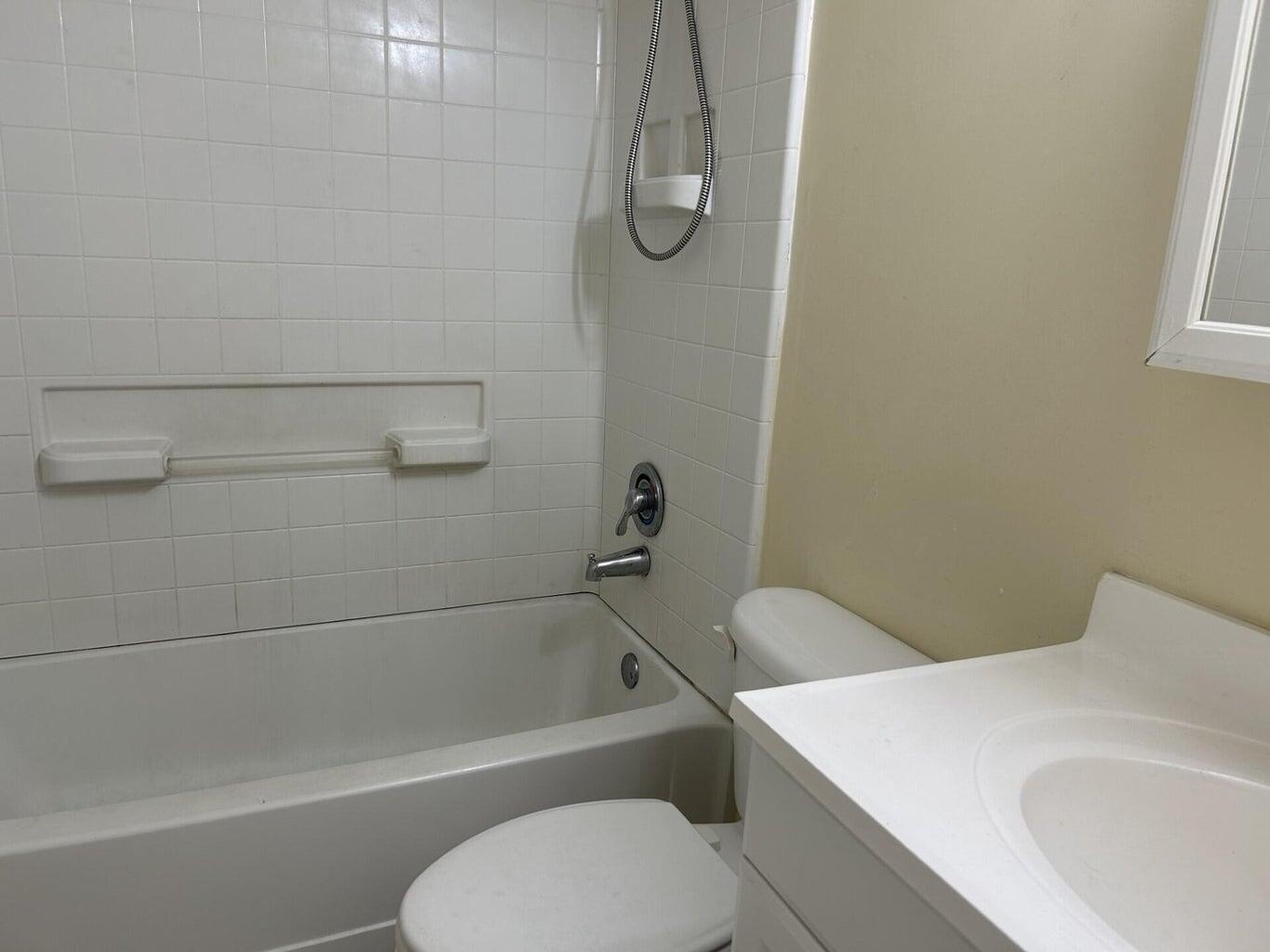 a bathroom with a toilet and a bath tub