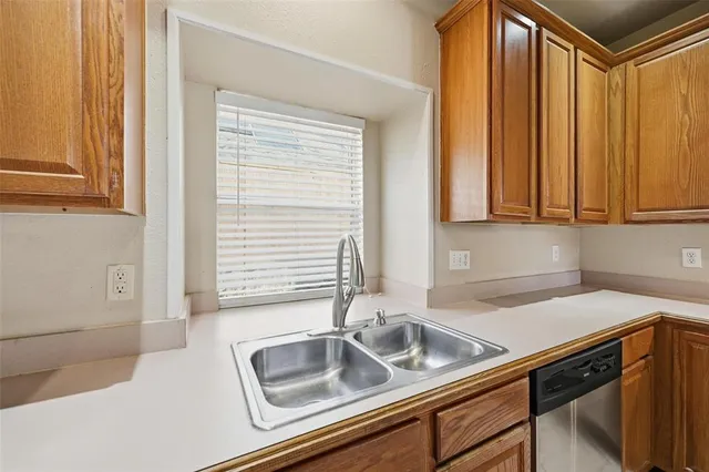 a kitchen with a sink cabinets and a window