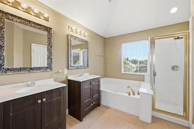 a bathroom with a tub sink and mirror