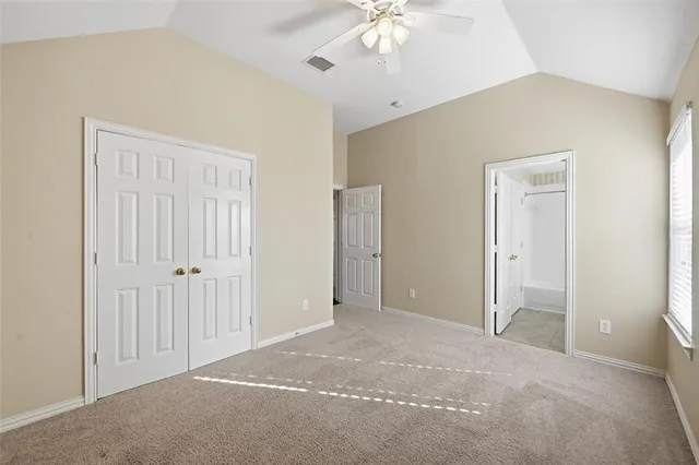 an empty room with a chandelier fan