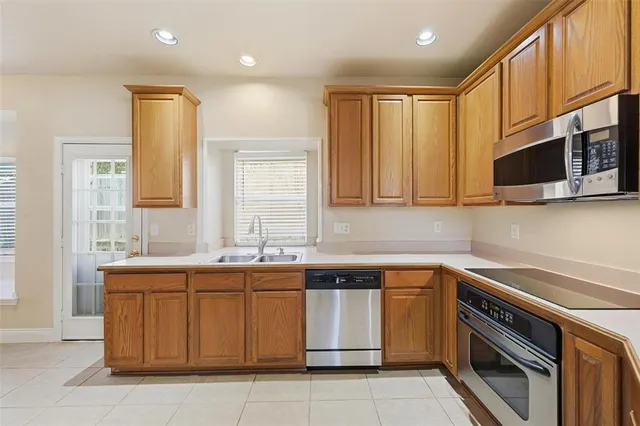 a kitchen with a sink stove and microwave
