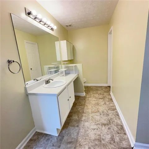 a bathroom with a double vanity sink mirror and shower