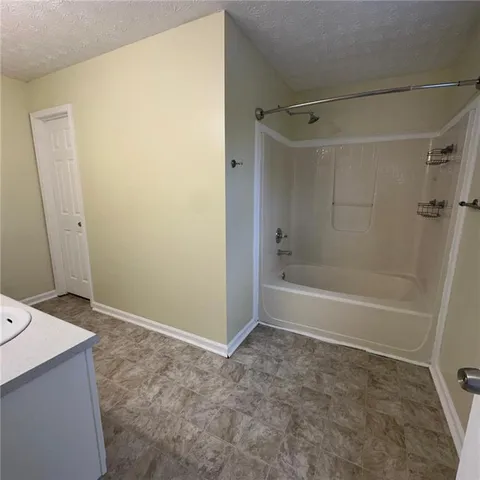 a bathroom with a bathtub and shower