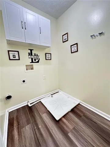 a view of a room with wooden floor and cabinet