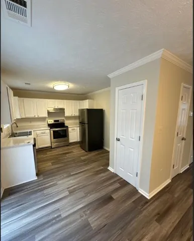 a view of kitchen with sink microwave and stove
