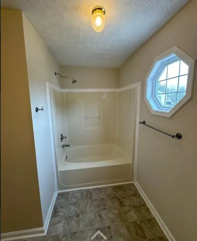 a bathroom with a bath tub and a shower
