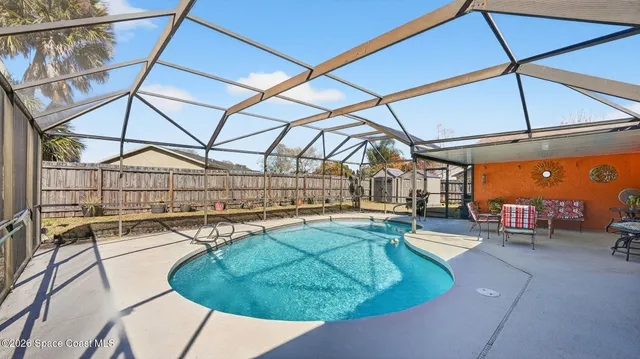 a view of a swimming pool with a patio