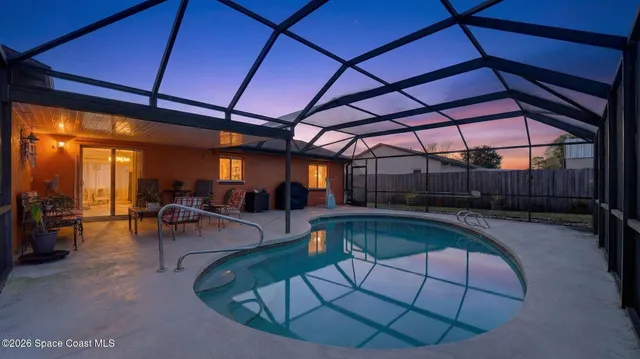 a view of a kitchen with wooden floor and a window