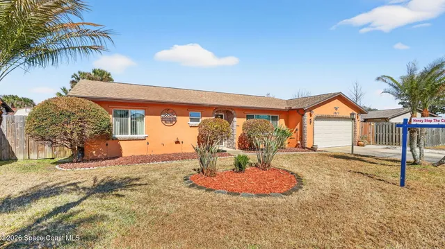 a room with a refrigerator and a wooden floor
