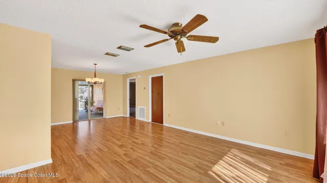 a view of a kitchen with wooden floor a sink and a window