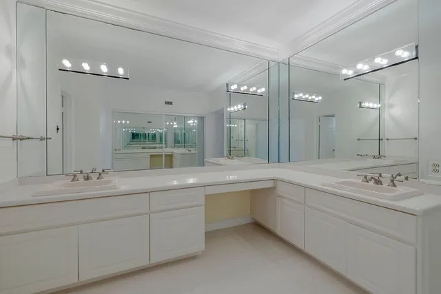 a bathroom with a sink double vanity and a mirror