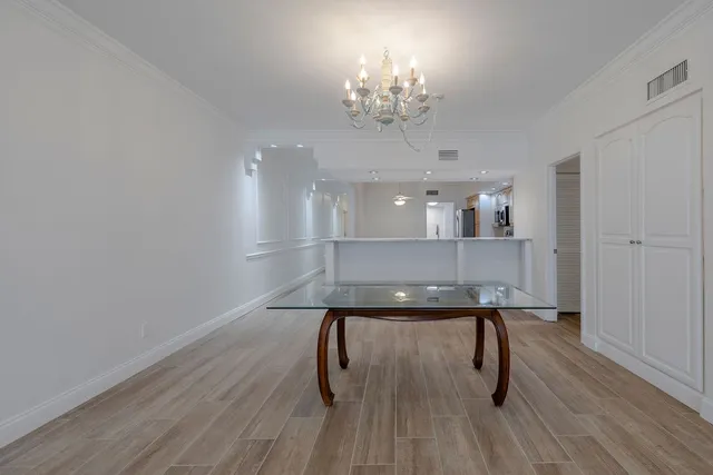 a view of a room with furniture and wooden floor
