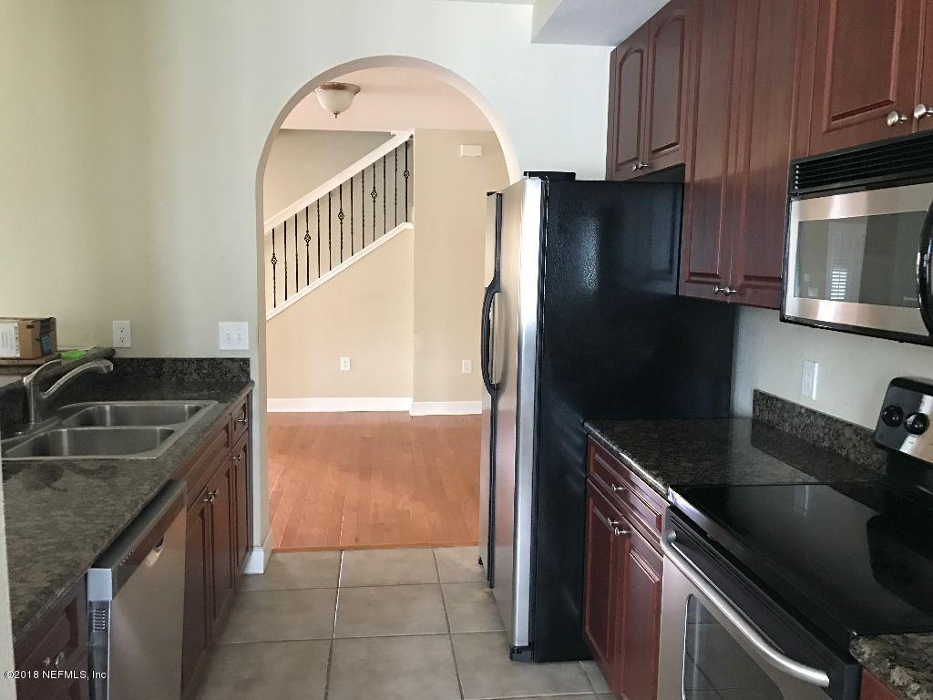 9745 Touchton Road, Unit 3008 Jacksonville, FL 32246 - Photo 2 of 22 a kitchen with granite countertop a sink stove and refrigerator