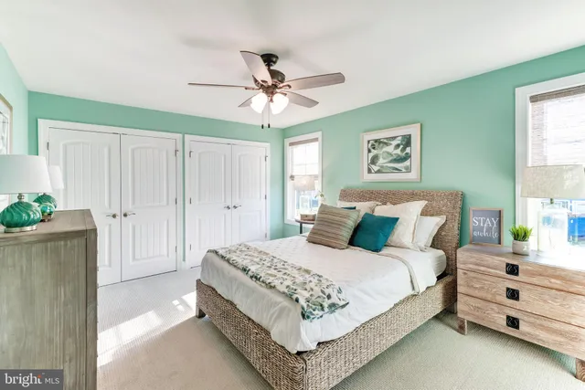 a bedroom with a bed and a ceiling fan