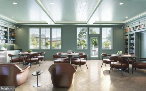 a living room with furniture and large windows