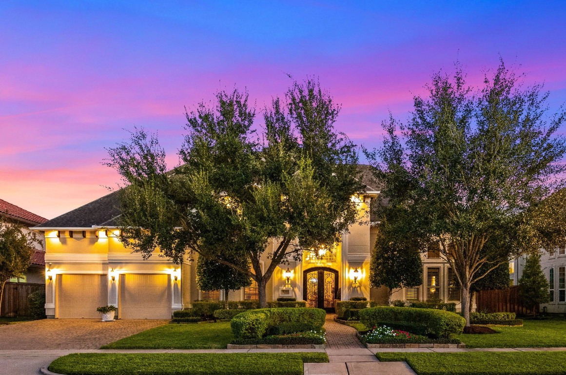 a view of a yard in front of a house with a trees