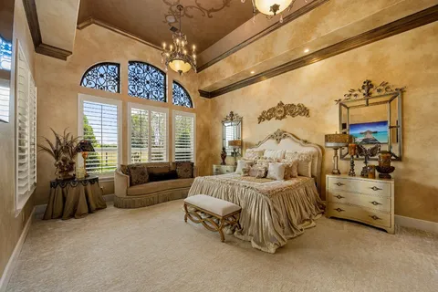 a spacious bedroom with a bed and a large window
