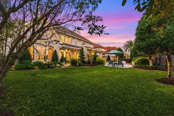 a view of an house with backyard space and garden