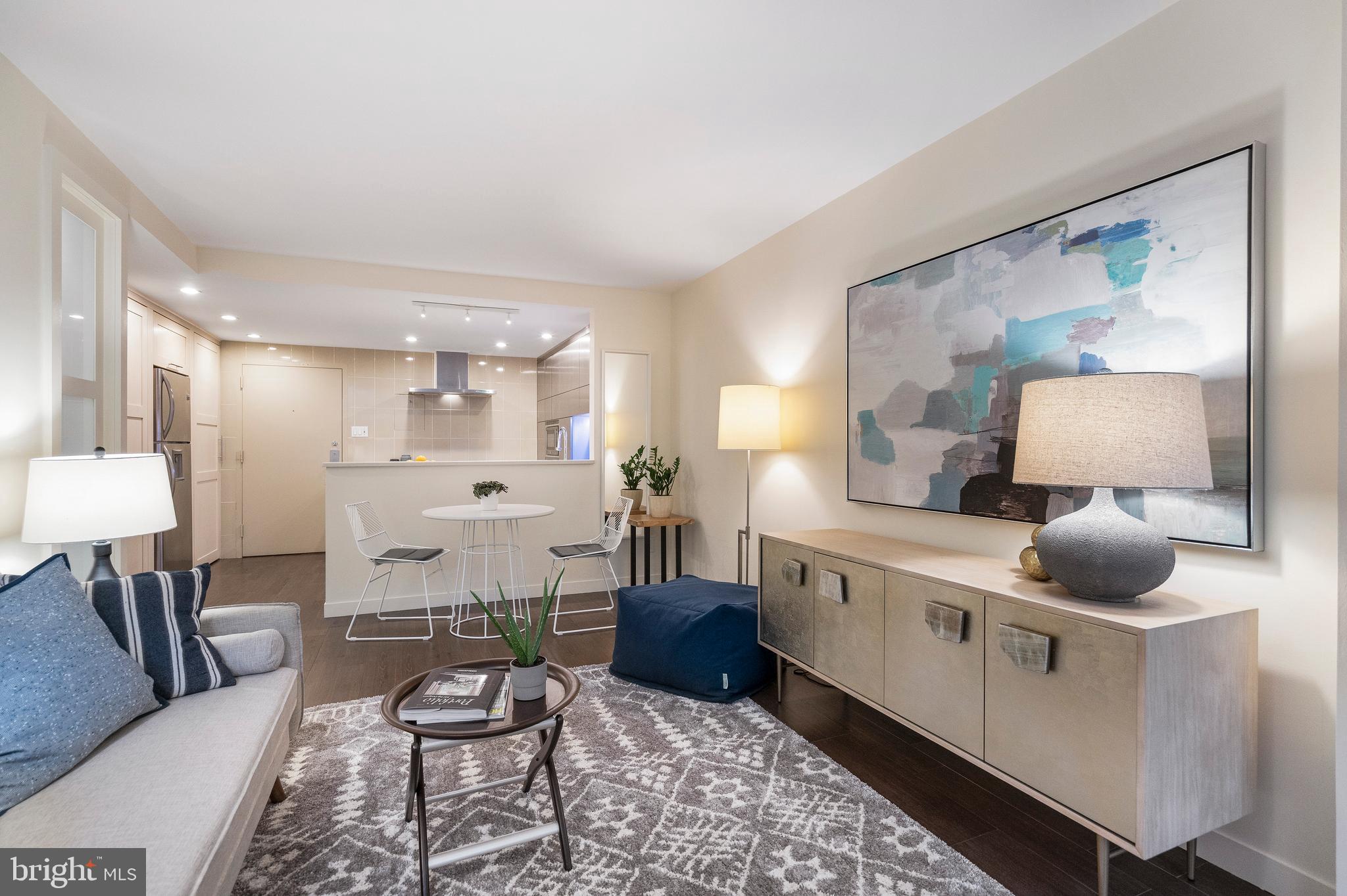 1301 20th Street Northwest, Unit 109 Washington, DC 20036 - Photo 12 of 33 a large white kitchen with a table and chairs