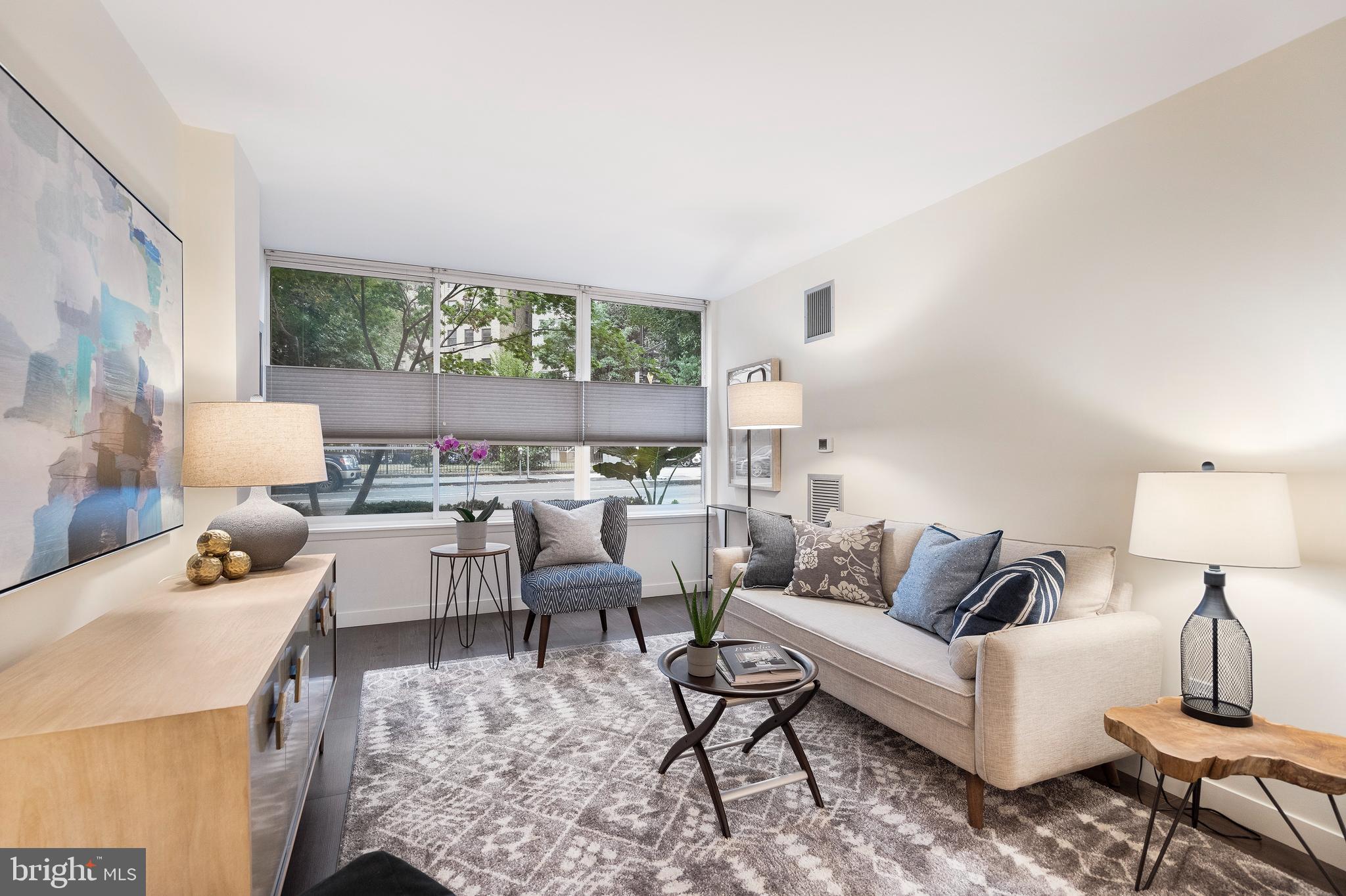 1301 20th Street Northwest, Unit 109 Washington, DC 20036 - Photo 13 of 33 a living room with furniture and a large window