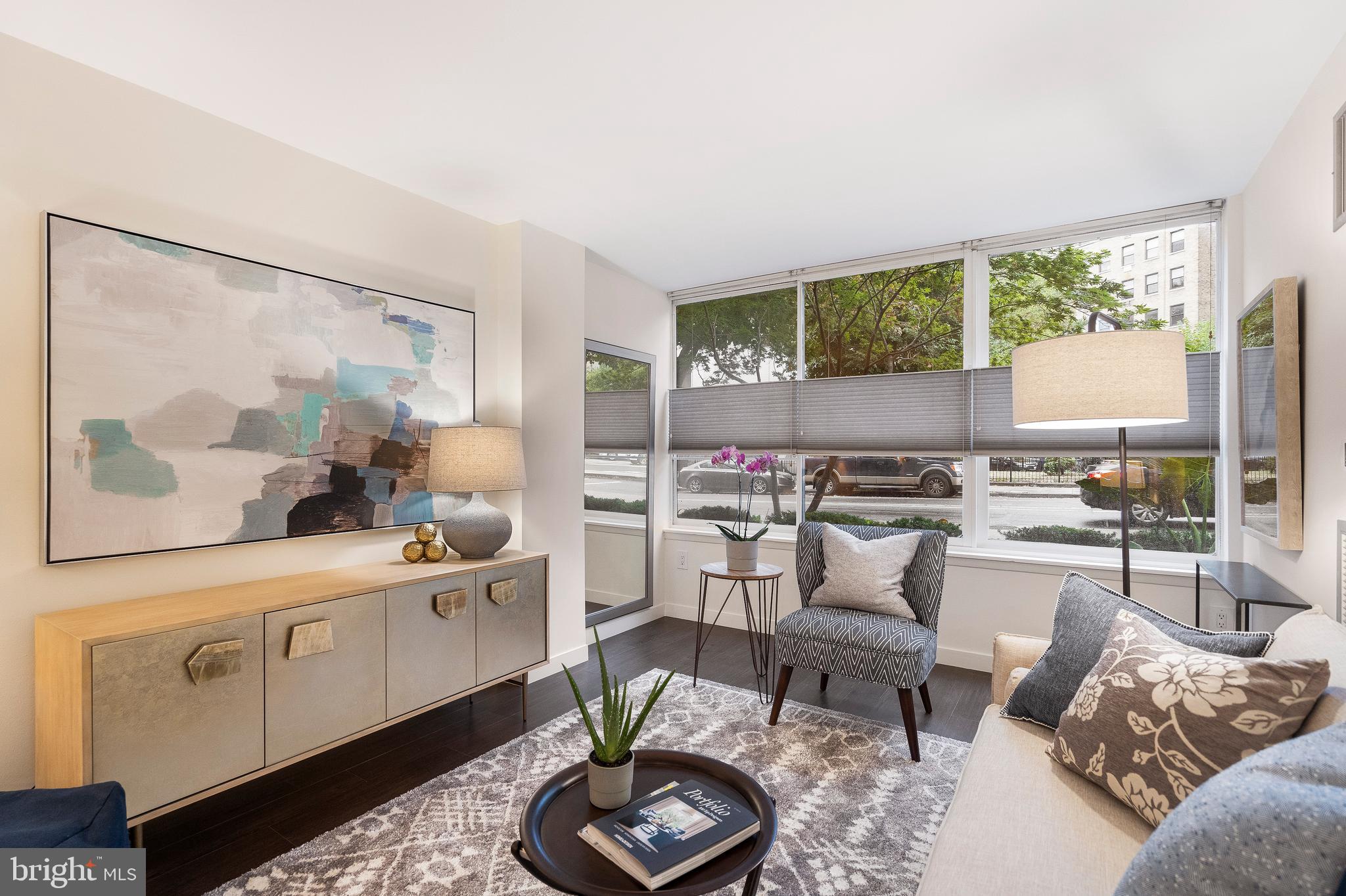 1301 20th Street Northwest, Unit 109 Washington, DC 20036 - Photo 14 of 33 a living room with furniture and a large window