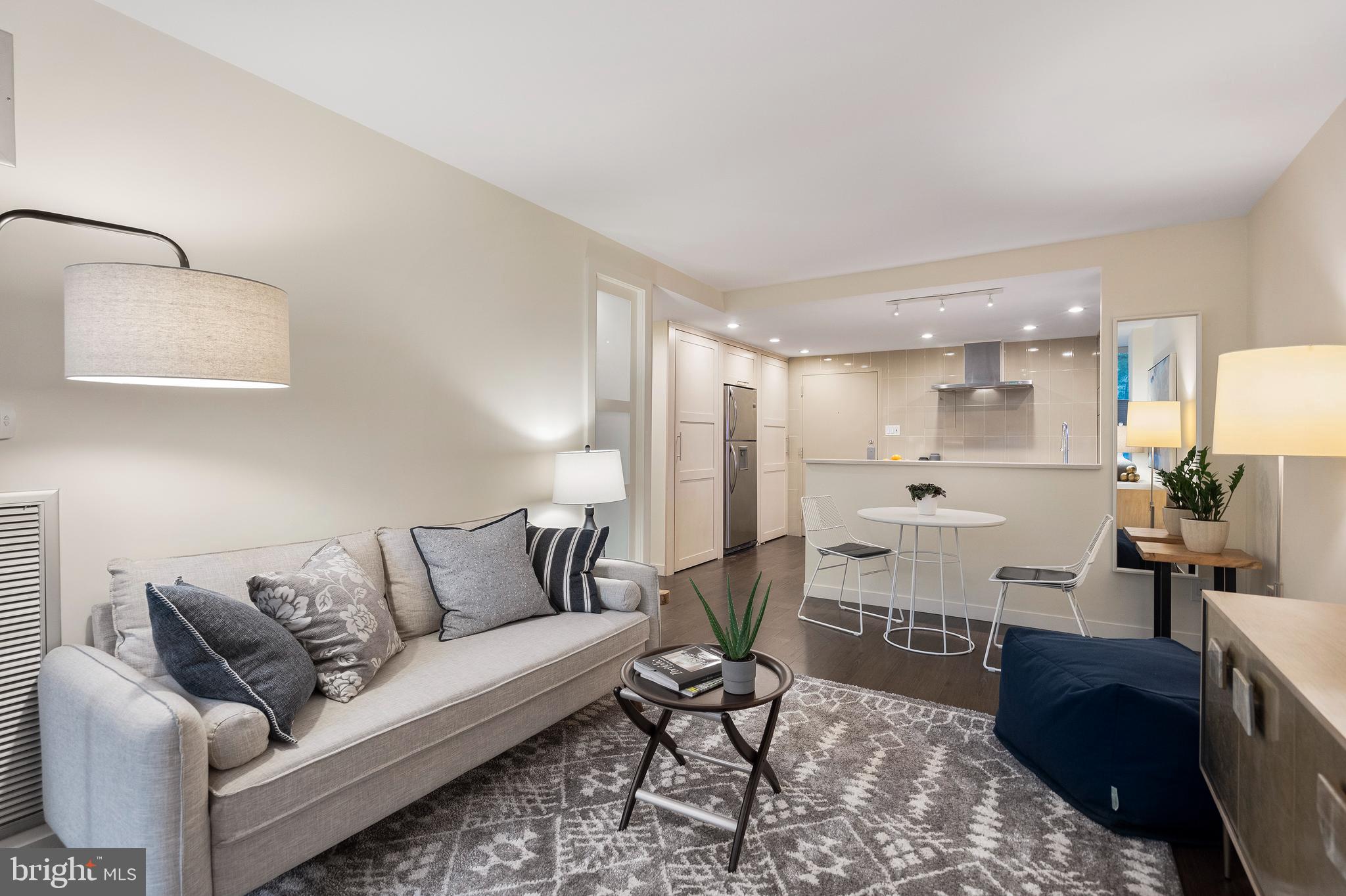 1301 20th Street Northwest, Unit 109 Washington, DC 20036 - Photo 15 of 33 a living room with furniture and a wooden floor