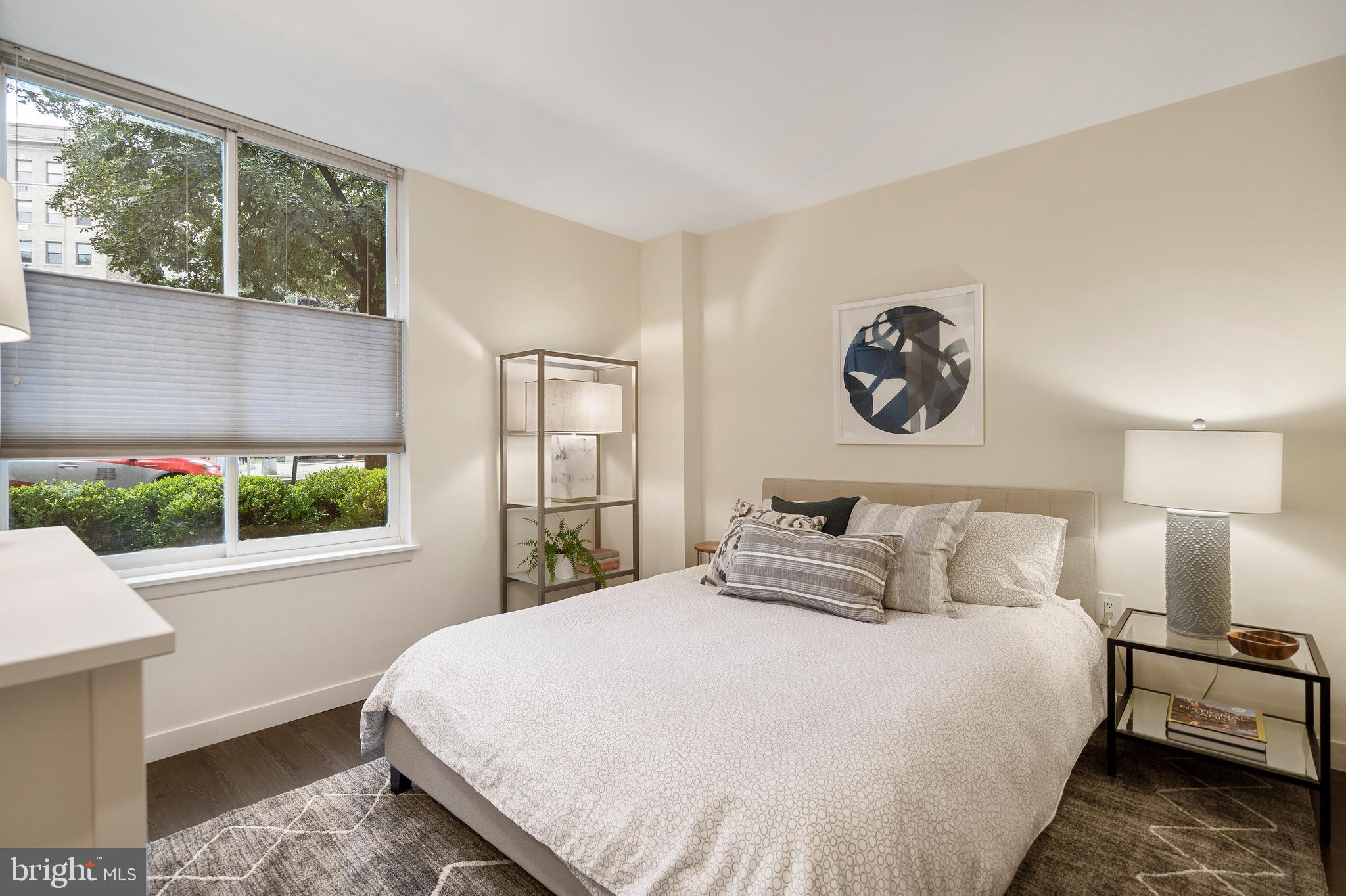1301 20th Street Northwest, Unit 109 Washington, DC 20036 - Photo 16 of 33 a bedroom with a large bed and a large window