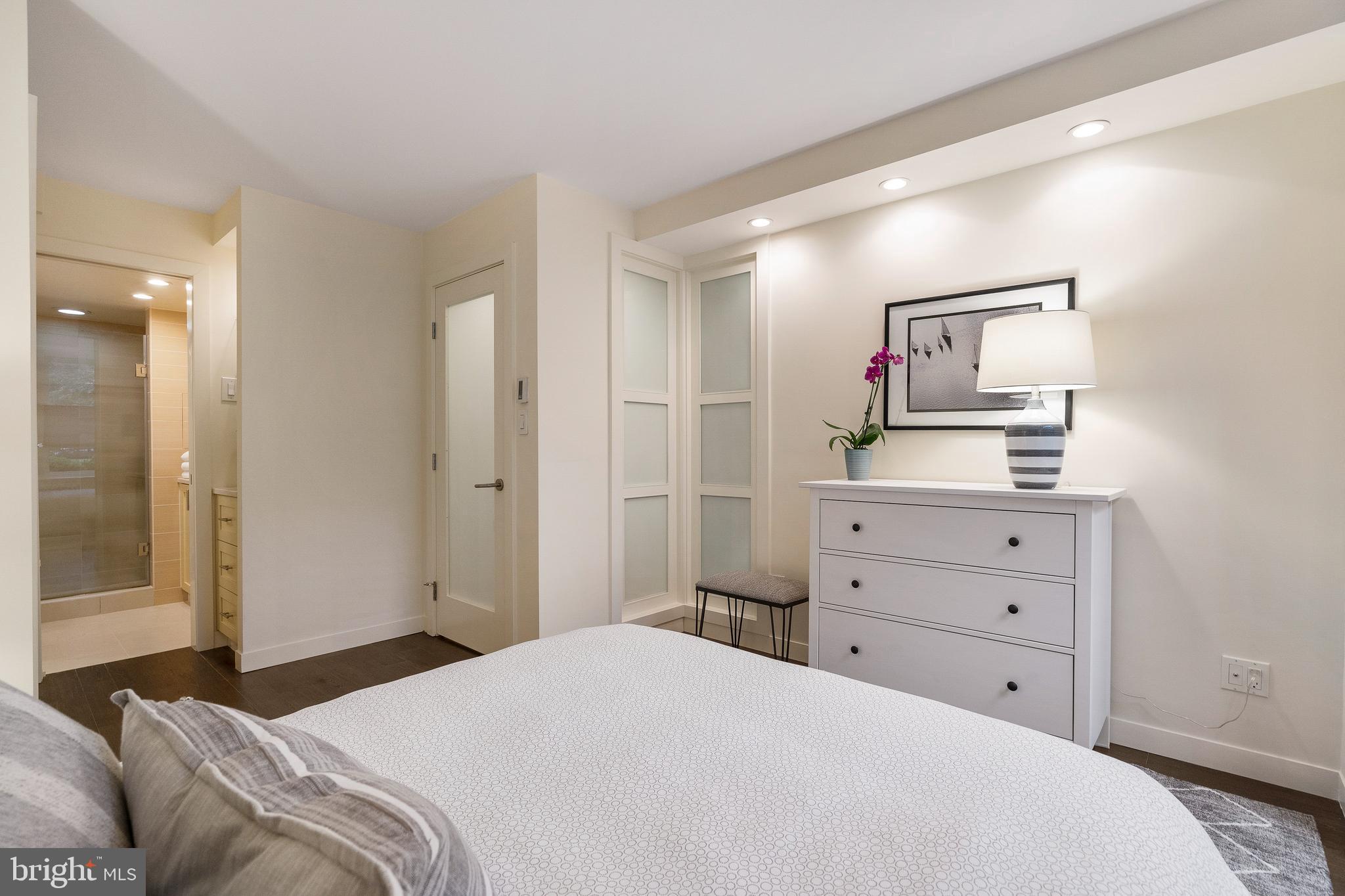 1301 20th Street Northwest, Unit 109 Washington, DC 20036 - Photo 18 of 33 a bedroom with a bed and a dresser