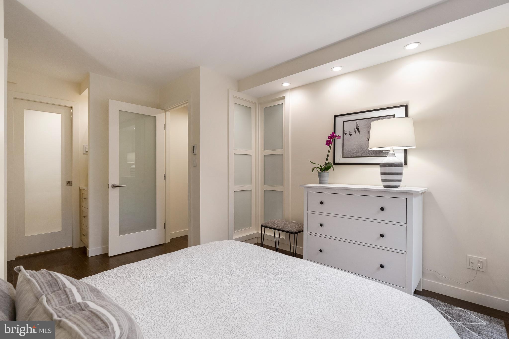1301 20th Street Northwest, Unit 109 Washington, DC 20036 - Photo 19 of 33 a bedroom with a bed and a dresser
