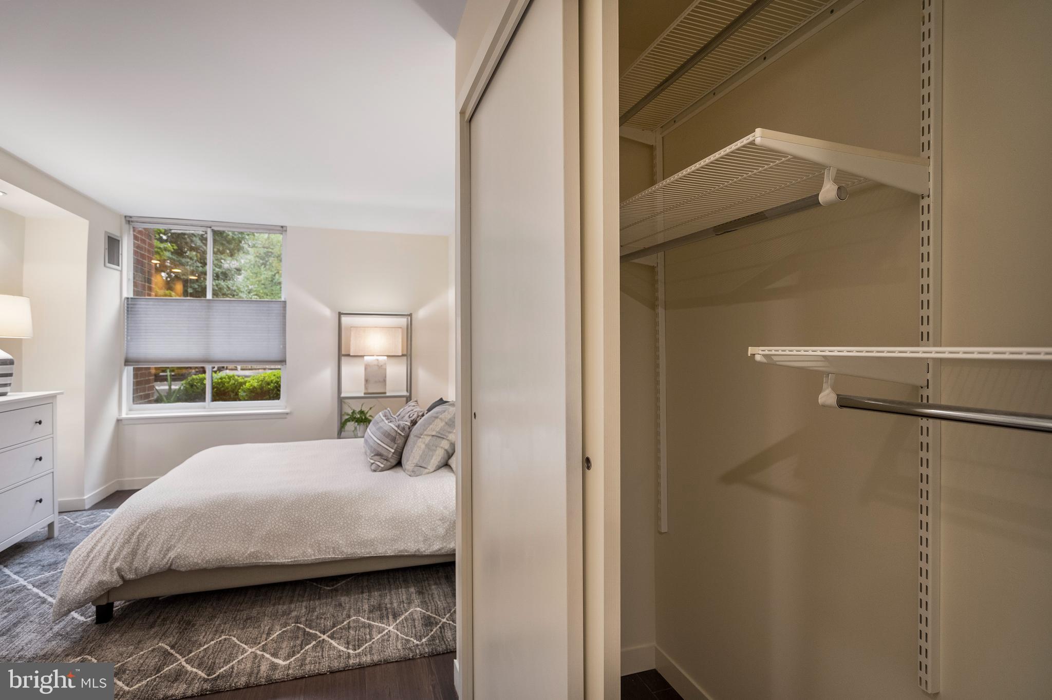 1301 20th Street Northwest, Unit 109 Washington, DC 20036 - Photo 20 of 33 a bedroom with a bed and a painting on the wall