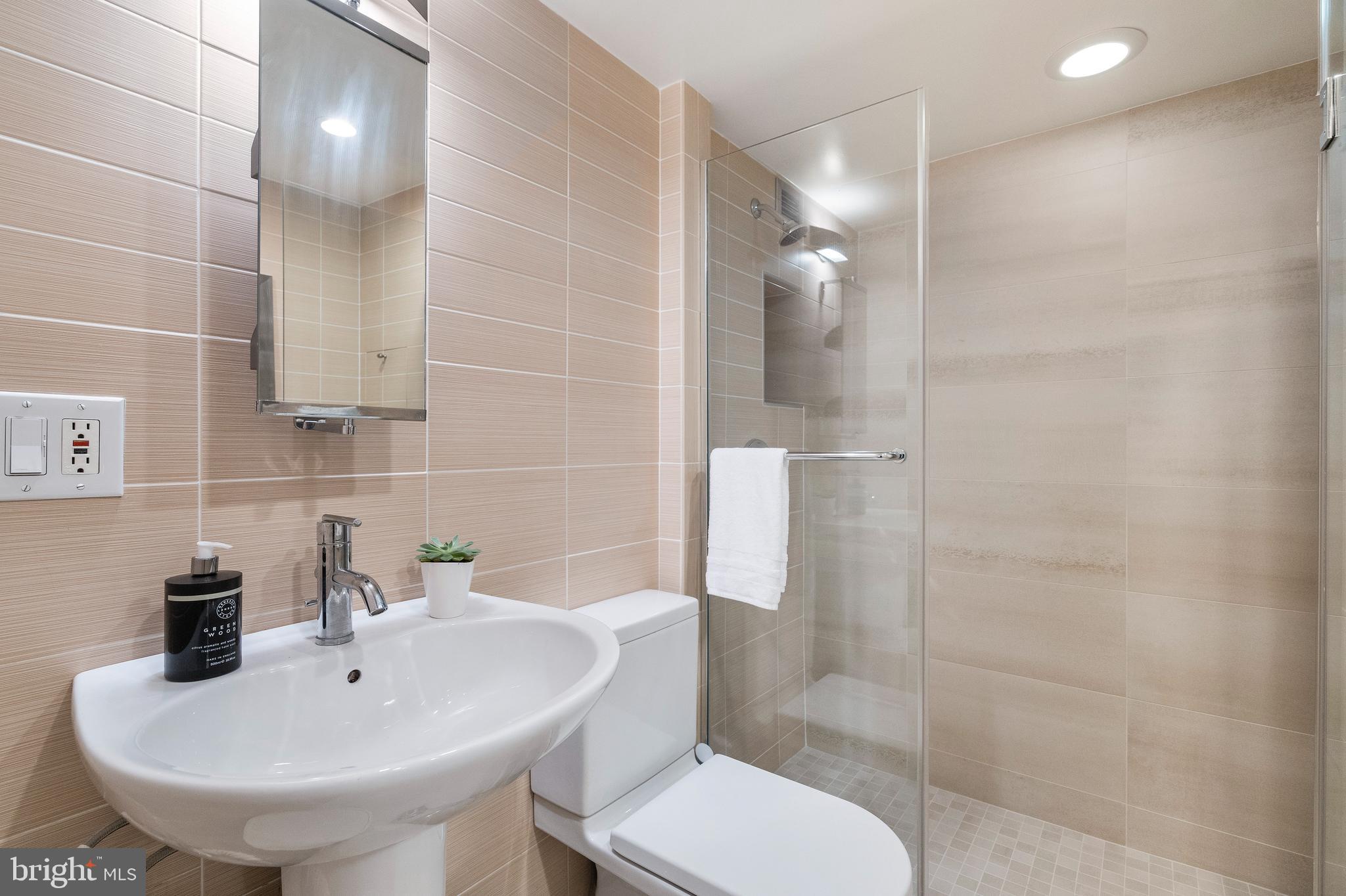 1301 20th Street Northwest, Unit 109 Washington, DC 20036 - Photo 21 of 33 a bathroom with a sink toilet and shower