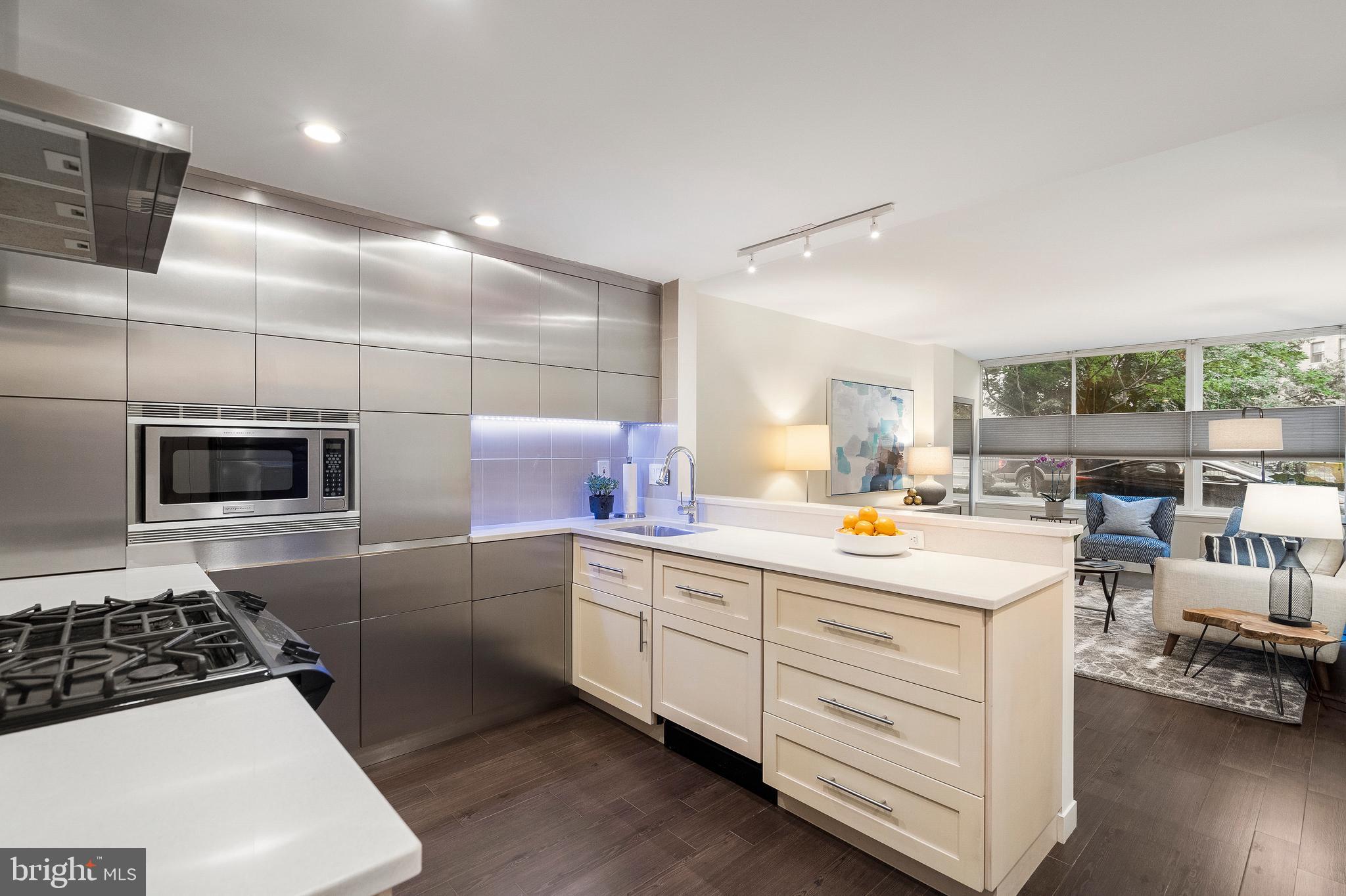 1301 20th Street Northwest, Unit 109 Washington, DC 20036 - Photo 4 of 33 a kitchen with counter top space cabinets and stainless steel appliances