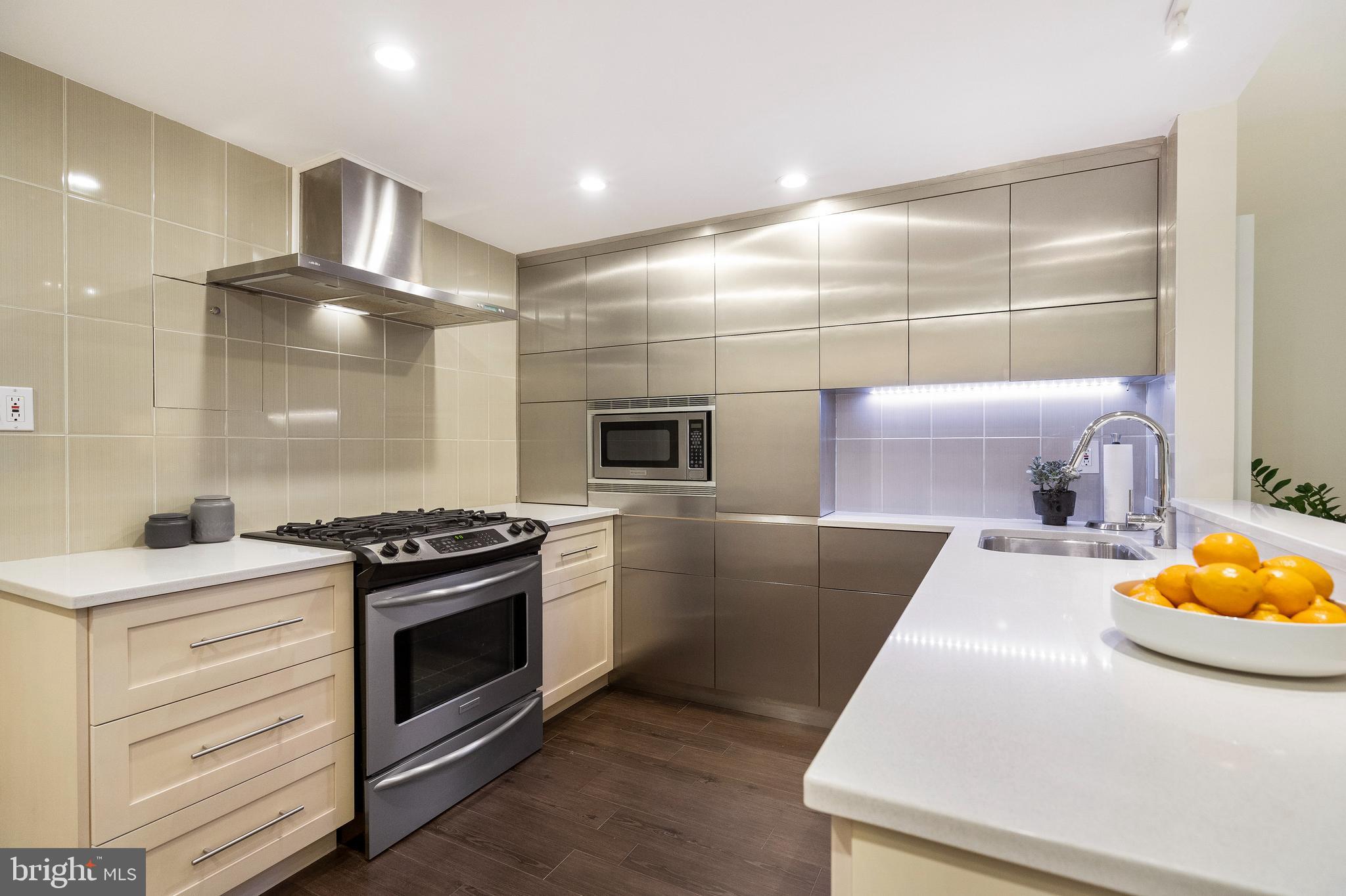 1301 20th Street Northwest, Unit 109 Washington, DC 20036 - Photo 5 of 33 a kitchen that has a sink and a stove