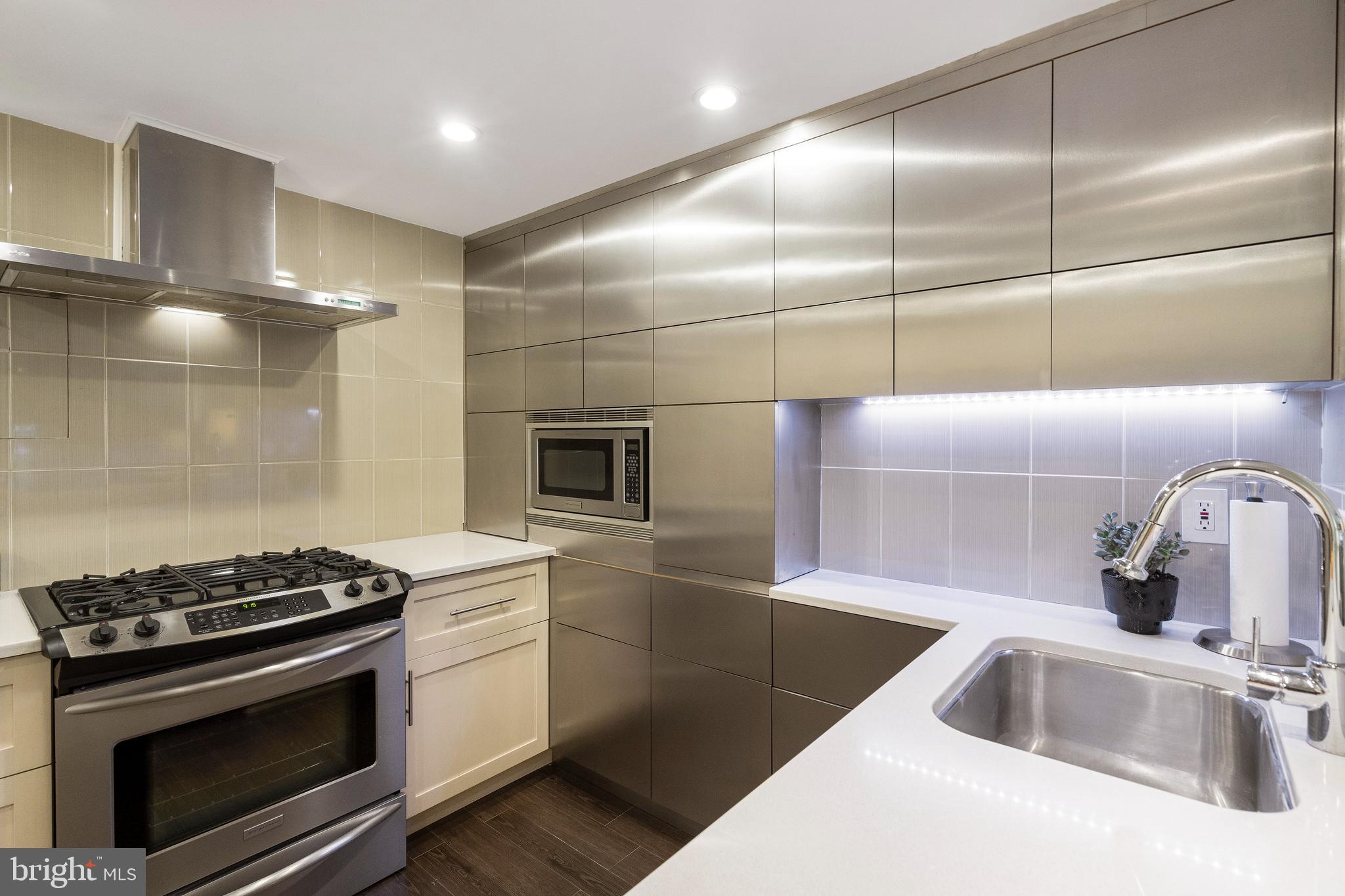 1301 20th Street Northwest, Unit 109 Washington, DC 20036 - Photo 6 of 33 a kitchen that has a sink and a stove