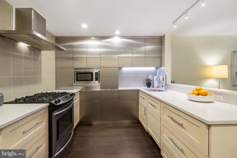 a kitchen with a sink stove and cabinets