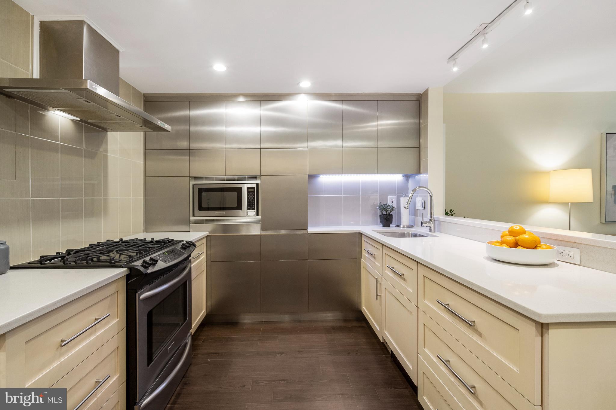 1301 20th Street Northwest, Unit 109 Washington, DC 20036 - Photo 7 of 33 a kitchen with a sink stove and cabinets