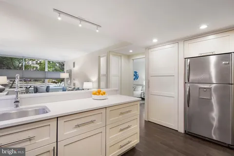 a kitchen with a refrigerator and a sink