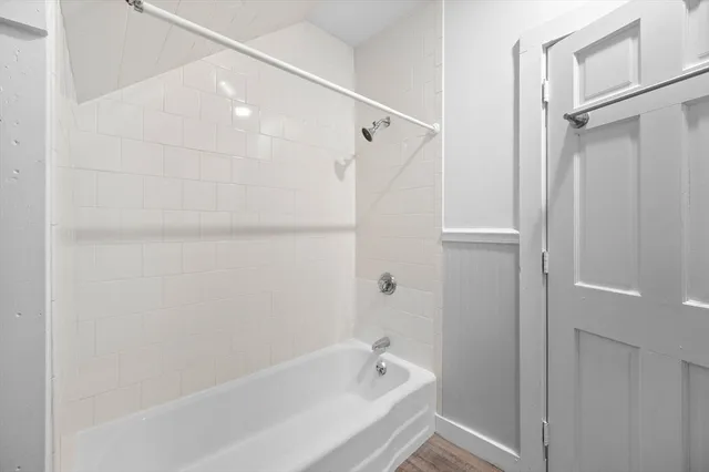 a bathroom with a bathtub and shower