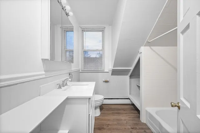 a bathroom with a sink a toilet and shower