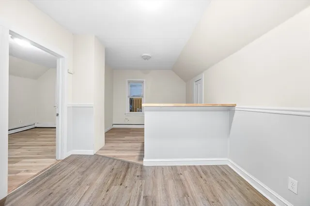 a view of an empty room and wooden floor