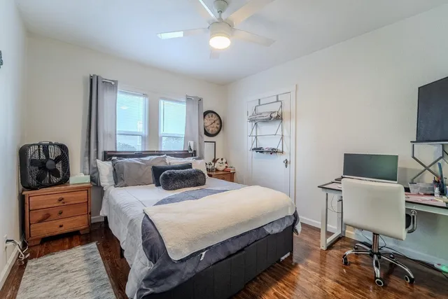 a bedroom with a bed and a chair in it