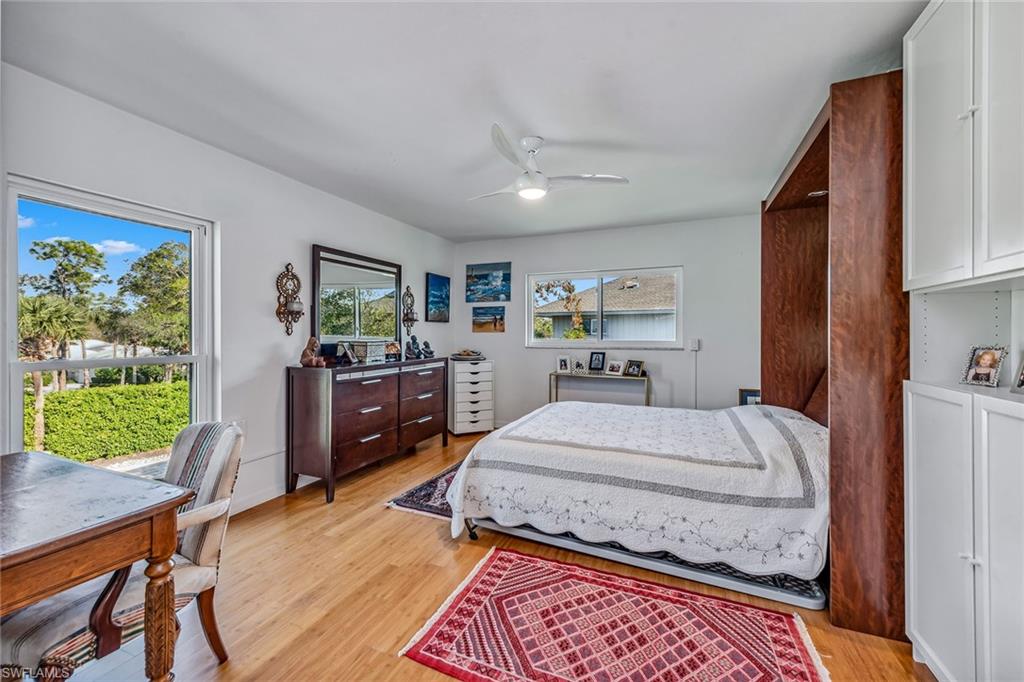 764 Eagle Creek Drive, Unit 301 Naples, FL 34113 - Photo 13 of 31 a bed room with a bed window and a dresser