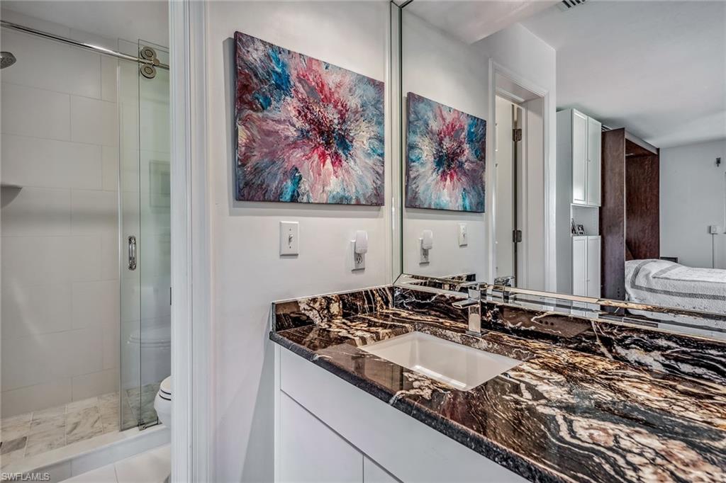 764 Eagle Creek Drive, Unit 301 Naples, FL 34113 - Photo 14 of 31 a bathroom with a granite countertop sink mirror and vanity
