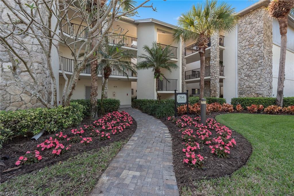 764 Eagle Creek Drive, Unit 301 Naples, FL 34113 - Photo 17 of 31 a view of a garden with flowers and flowers