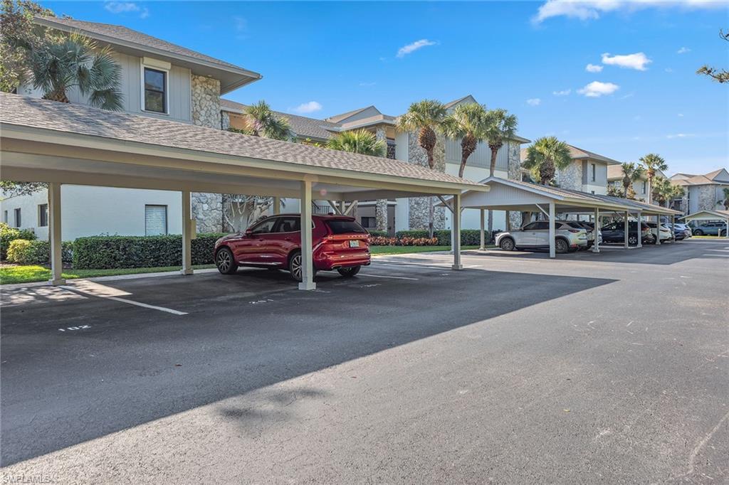 764 Eagle Creek Drive, Unit 301 Naples, FL 34113 - Photo 18 of 31 a car parked in front of the building